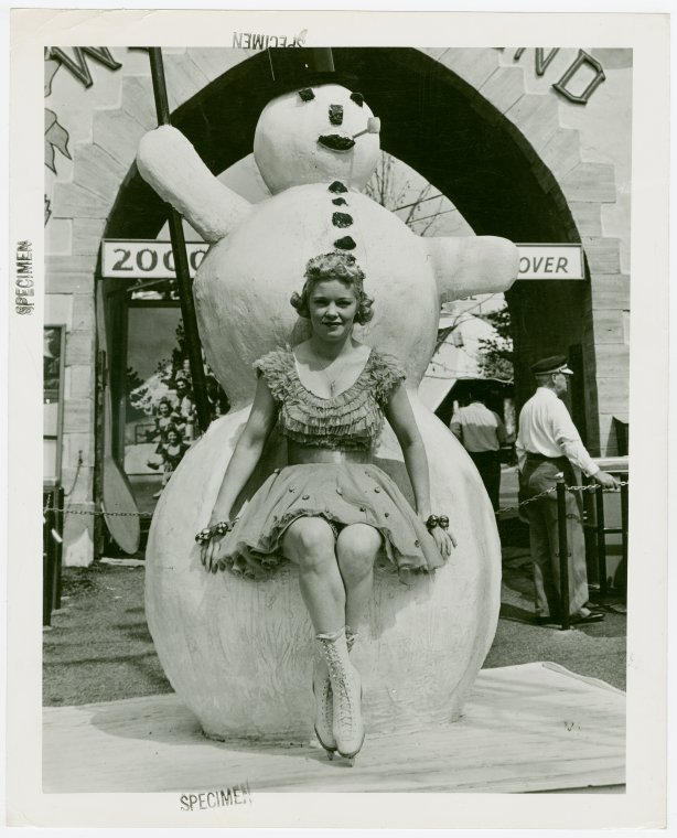 Sports - Ice Skating - Woman in ice skates posed with snowman, Digital ID 1683153, New York Public Library
