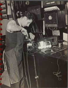 [student repairing a radio] Digital ID: 3926023. New York Public Library