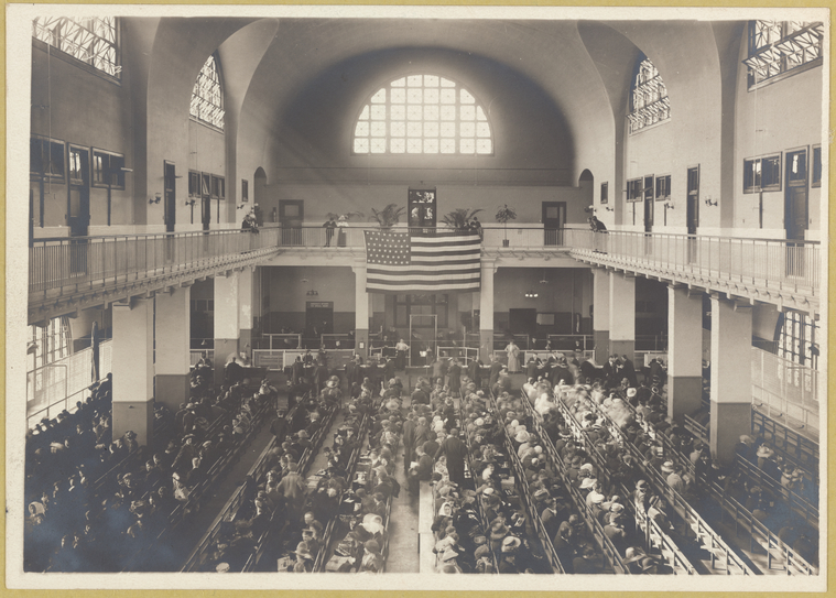 Immigrants seated on long benches, Main Hall, U.S. Immigration Station., Digital ID 417074, New York Public Library