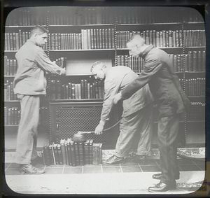 Three men at dusting books Digital ID: 1153325. New York Public Library