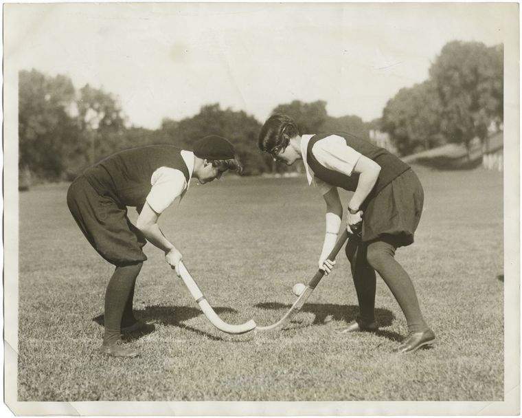 Bully! : the start of a hockey game played by Agnes Rodgers (left) of Philadephia, and Marion Neilson of Darien, Conn., two students at Smith College, Northampton, Mass.