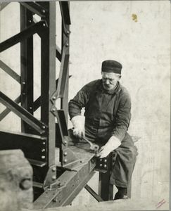 Worker attaching a bolt onto a... Digital ID: 79857. New York Public Library