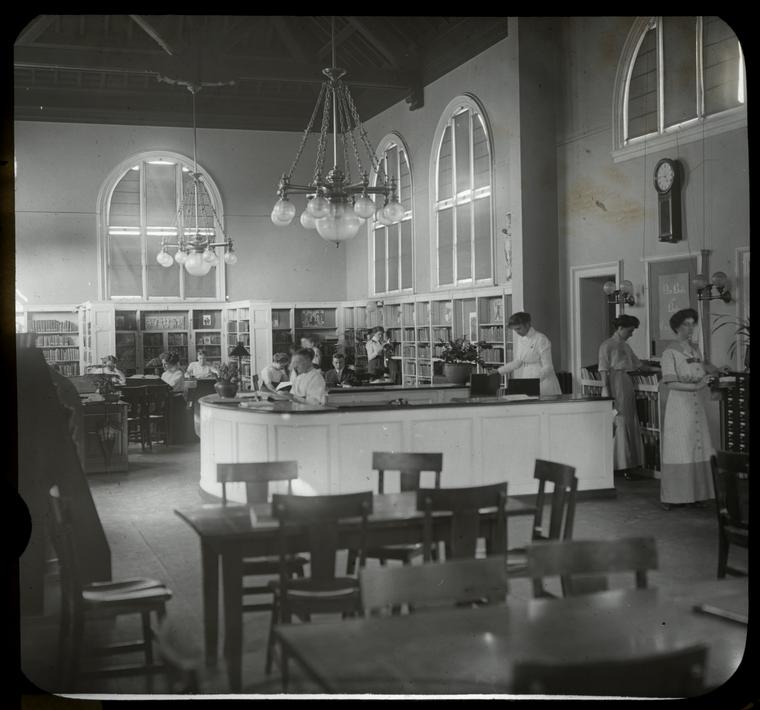 women at desk, card catalog and shelves, Digital ID 100965, New York Public Library