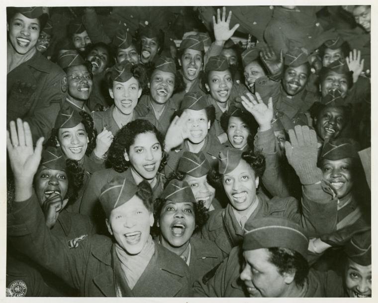 [A crowd of African American Women's Army Corps members waving at the camera, Staten Island Terminal, New York Port of Embarkation, March 13, 1946.],Home again., Digital ID 1260330, New York Public Library