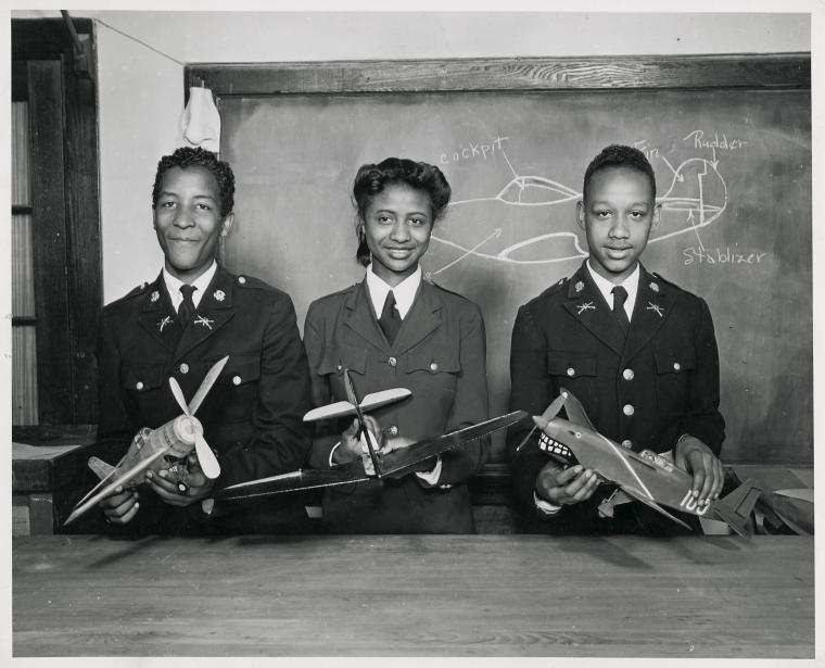 Washington, D.C., public schools go to war.,[African American schoolchildren holding model airplanes and learning types of fighter planes during their civil defense class.], Digital ID 1260420, New York Public Library