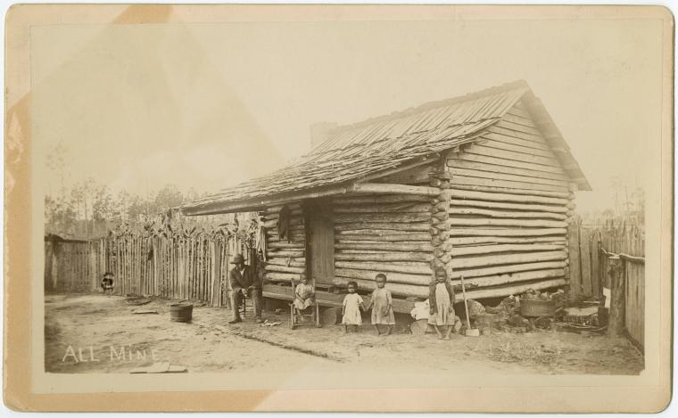 [Man and children in front log cabin], Digital ID 1629328, New York Public Library