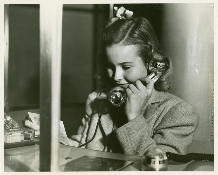 American Telephone & Telegraph Exhibit - Close-up of girl on phone, Digital ID 1652482, New York Public Library