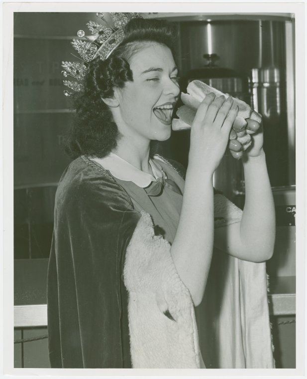 Special Days - Hot Dog Day - Winner of Most Beautiful Waitress contest eating hot dog, Digital ID 1682269, New York Public Library