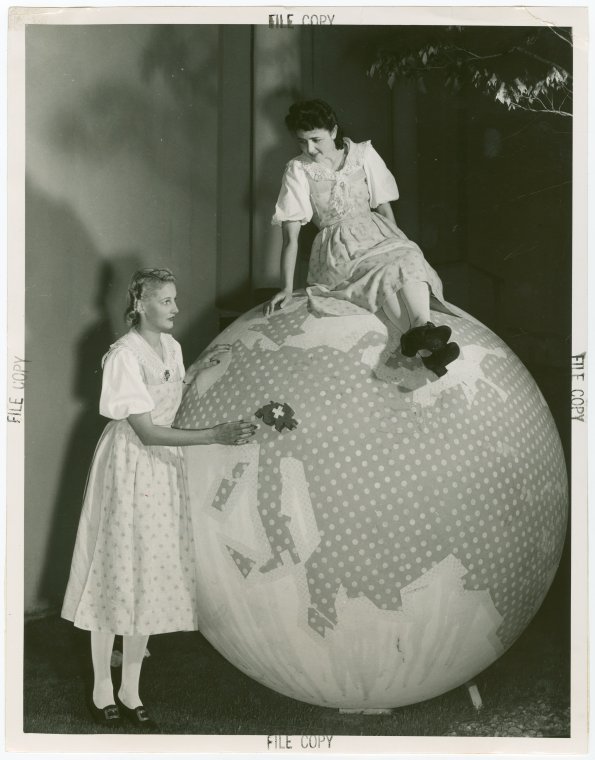 Switzerland Participation - Women with large ornamental globe, Digital ID 1683617, New York Public Library