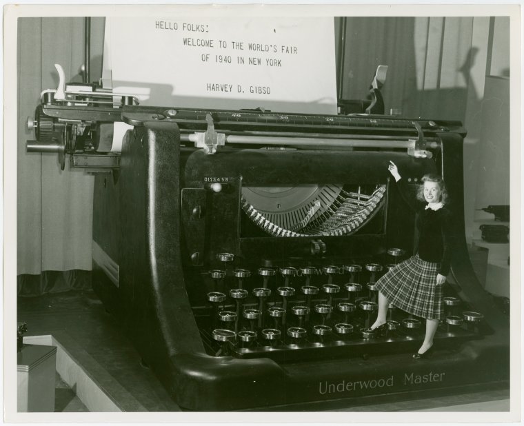 Underwood Elliott Fisher Co. - Woman posing with giant typewriter, Digital ID 1685589, New York Public Library