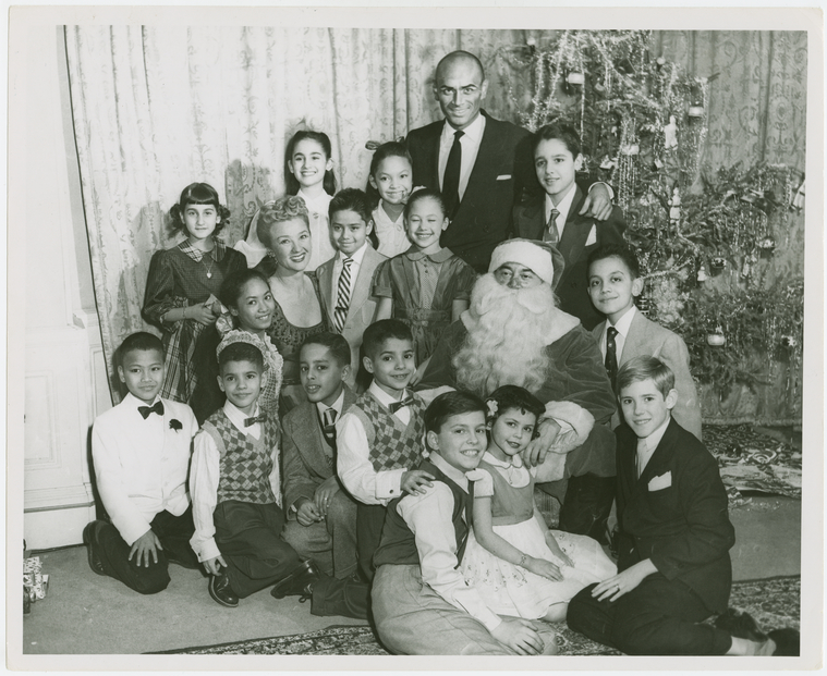 [Yul Brynner (The King), Constance Carpenter (Anna Leonowens replacement) and children of The King and I at a Christmas party],King and I (musical), by Rodgers & Hammerstein,Xmas party for children appearing in The King and I, Digital ID 1712899, New York Public Library