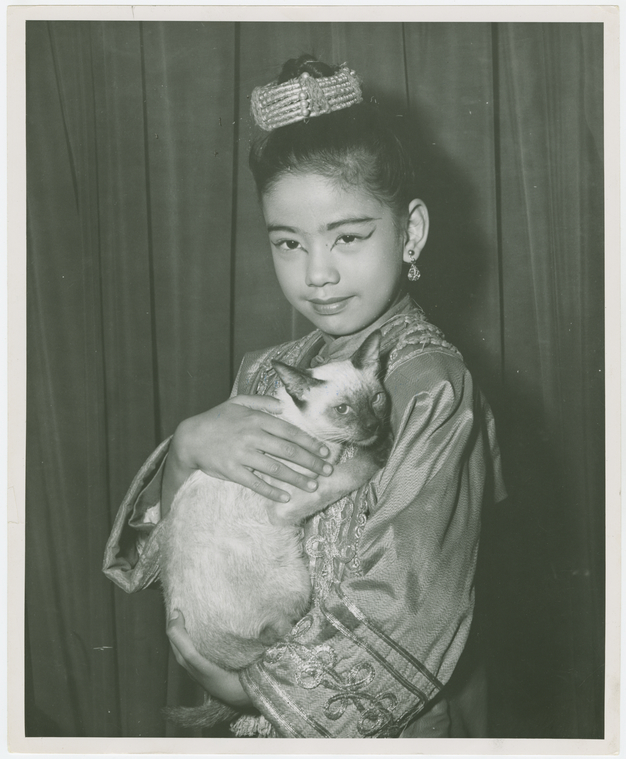 King and I (musical), by Rodgers & Hammerstein,[Carole Luna (Royal Child replacement) holding Somawadi the cat backstage at The King and I], Digital ID 1712912, New York Public Library