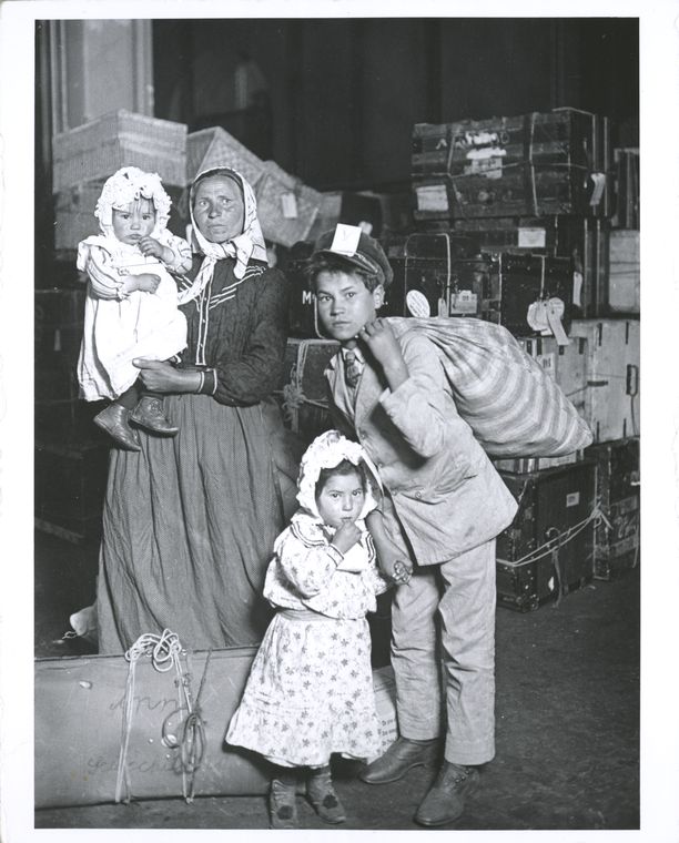 Immigrant family looking for lost baggage, Ellis Island, Digital ID 79887, New York Public Library