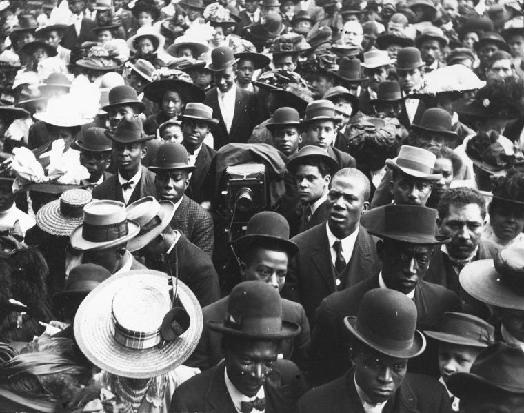 A photographer amid a crowd outdoors.,[Photographer in a crowd.], Digital ID DS_03SCAPB, New York Public Library