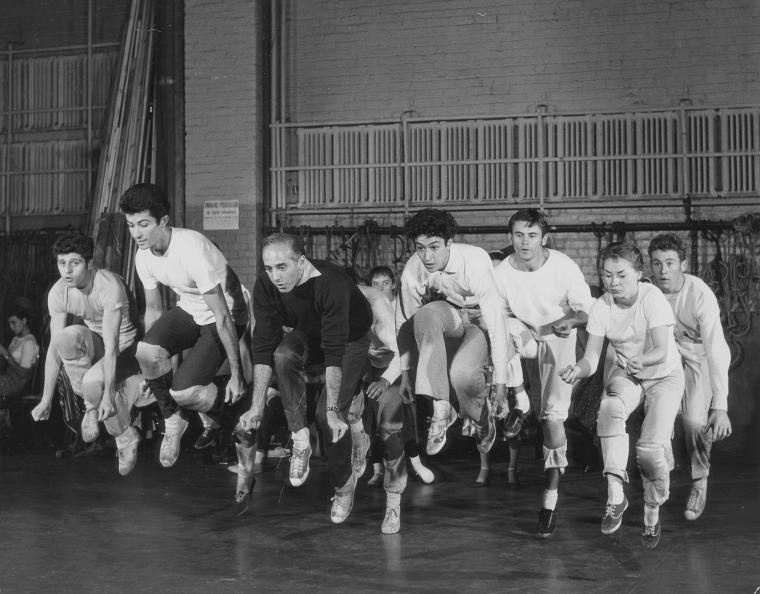 Jerome Robbins leading dancers (including Tony Mordente and George Chakiris) rehearsing "Cool" number for West Side Story., Digital ID psnypl_the_4938, New York Public Library