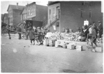 Chicago YMCA, Clean-up Campaign. [Young children pulling baskets with cans through the streets.]