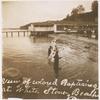 Postcard of adult men and women being baptized at the water's edge.