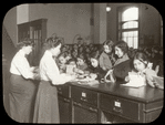 Hamilton Fish, children at charge desk covering their books with wrapping paper