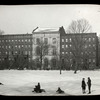 Winter in Harlem, boys sleighing in front of library building