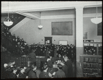 96th Street, Adult room, 1923, showing people at desk, and stairway filled with people