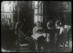 Riverside, girls sitting in a circle by a sunny window, plants nearby