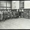 Rivington Street, line waiting for easy books, 1923: Librarian holds up book and those who want it raise their hands