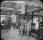 Seward Park interior views, young men at reference desk, closed shelves