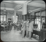 Seward Park interior views, young men at reference desk, closed shelves