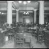 Tremont, looking out from desk toward entrance thronged with people