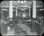 Tremont, looking out from desk toward entrance thronged with people