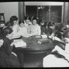 Tremont, interior view, girls gathered around table reading under guidance of "Miss Farren(?)"  "...ford Club,"