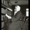 Webster: Interior views, Bohemian reader, woman in long dark dress, white scarf