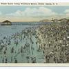 Beach Scene Along Woodland Beach, Staten Island, N.Y.  [pier, pavilion, people on beach and in water].