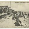 Bathing at Graham Beach, Staten Island, N.Y.  [people on sand with boardwalk and restaurant.]