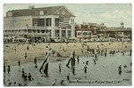 Water Maneuvering at Midland Beach, Staten Island, N.Y.  [card # upside down] [Pavilion with large flag, people in water, other buildings.]