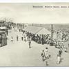 Boardwalk Midland Beach, Staten Island, N.Y. [people, waffle stand, ferris wheel in background, sun shelter.]