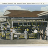 20144 Largest Souvenir and Novelty Store, South Beach, Staten Island, N.Y. [concession stand of Souveniers(sic) and Post Cards, people posed out front]