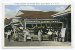 20144 Largest Souvenir and Novelty Store, South Beach, Staten Island, N.Y. [concession stand of Souveniers(sic) and Post Cards, people posed out front]