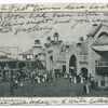 Happyland, South Beach, Staten Island.  [turreted entrance building next to electric theatre,  with people at boardwalk railing looking out over water.]