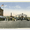 Bergen Point Ferry, Port Richmond, Staten Island, N.Y. [entrance to ferry, two ferries docked, people in old garb walking about, old touring car parked at entrance gate, restaurant with sign in front advertising various seafoods]