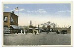 Bergen Point Ferry, Port Richmond, Staten Island, N.Y. [entrance to ferry, two ferries docked, people in old garb walking about, old touring car parked at entrance gate, restaurant with sign in front advertising various seafoods]