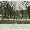 Washington Park and Village Hall, Stapleton, Staten Island  [view of park with old brick village hall and many men strolling the paths]