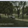 Washington Park, Stapleton, Staten Island, N.Y. (people sitting on benches along walkway, shops on street