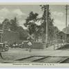 Richmond Avenue, Eltingville, S.I., N.Y.  [R.R. crossing, station, train at platform, old car stopped by tracks, "Reid's" soda-drug-ice cream store on street]