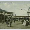 Trolley Station at South Beach, Staten Island [people in old garb standing on boardwalk by the electric car,  buildings and hotel on side and background]