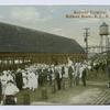 Railway Terminal, Midland Beach, Staten Island, N.Y.  [people waiting on station platform, ladies in old-fashioned dresses and men in straw hats, wooden water tower in background]