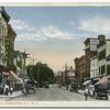 Bay Street, Stapleton, Staten Island, N.Y. [old cars in street, horse and wagon, people walking, red-striped awnings on shops, sign for hotel, sign on building  E.D. Wayman Dry Goods and Millinery]