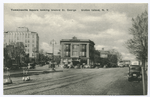 Tompkinsville Square looking toward St. George, Staten Island, N.Y.  [old cars, old gas lamps, brick street, large buildings]