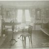A New England parlor of about 1800 showing carved wooden mantel, fire screen and spinet.
