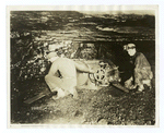 Miners adjusting a machine in a mine